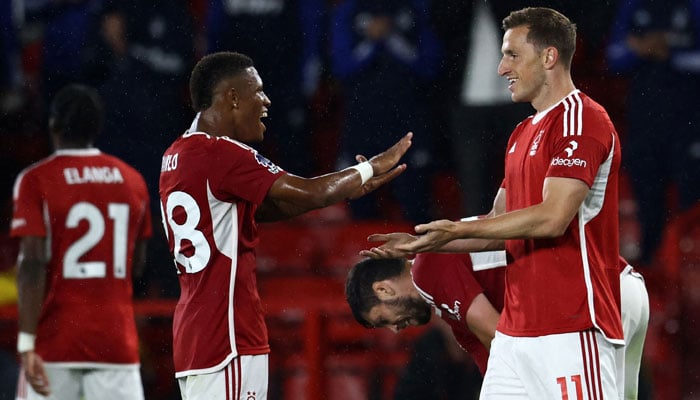 Nottingham Forest´s New Zealand striker #11 Chris Wood (R) celebrates with Nottingham Forest´s Brazilian midfielder #28 Danilo (2L) after scoring their second goal during the English Premier League football match between Nottingham Forest and Sheffield United at The City Ground in Nottingham, central England, on August 18, 2023. AFP
