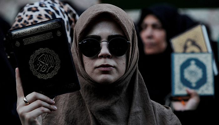 Protesters hold copies of the Koran as they demonstrate outside the Consulate General of Sweden in Istanbul, Turkey, July 30, 2023. — Reuters