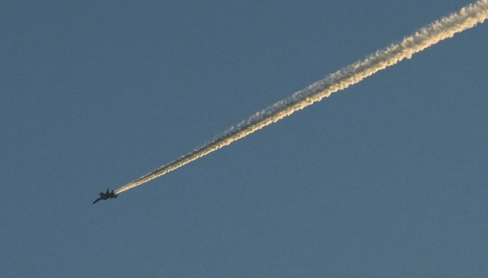 A Chinese Peoples Liberation Army (PLA) aircraft flies over the 68-nautical-mile to the island of Taiwan. — Reuters