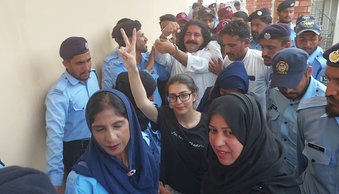 Human rights lawyer Imaan Mazari (bottom centre) and PTI leader Ali Wazir being escorted to a court by Islamabad police on August 20, 2023. — by reporter