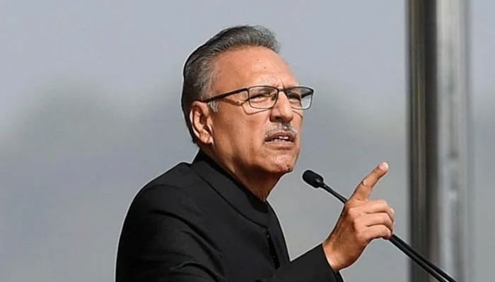 President Arif Alvi gestures during an address. — AFP/File