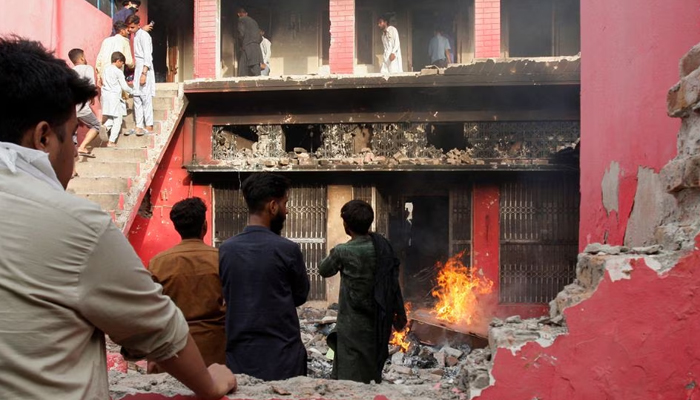 People gather at a church building vandalized by protesters in Jaranwala, Pakistan August 16, 2023. — Reuters