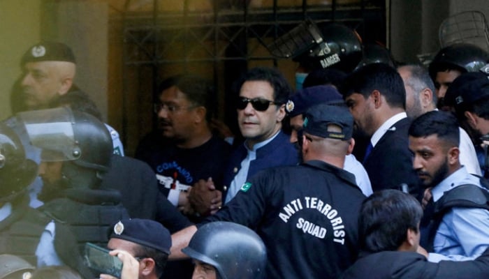 Security officers escort Pakistan’s former Prime Minister Imran Khan outside Islamabad High Court, Islamabad, Pakistan, May 12, 2023. — Reuters