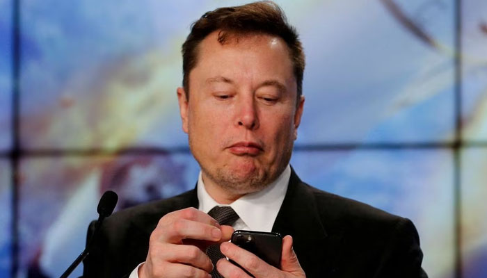 Elon Musk looks at his mobile phone in Cape Canaveral, Florida, US. — Reuters