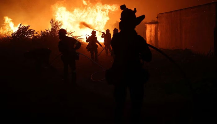 Firefighters try to extinguish a wildfire burning near the village of Makri on the region of Evros, Greece, August 22, 2023.—Reuters