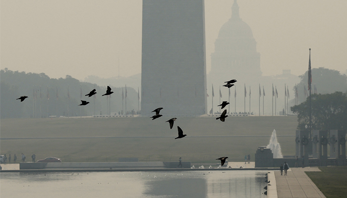 Wildfire smoke casts a haze over the National Mall on June 07, 2023, in Washington, DC. — AFP
