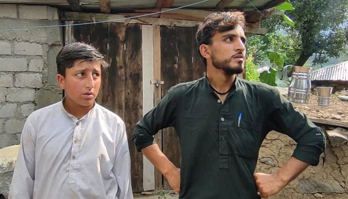 Gulfaraz (right) stands with a fellow survivor in Battagram on August 23, 2023. — Photo by author