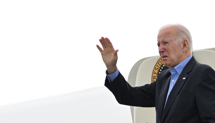 US President Joe Biden waves while boarding Air Force One at Reno-Tahoe International Airport in Reno, Nevada, on August 21, 2023, as he departs for Hawaii. — AFP