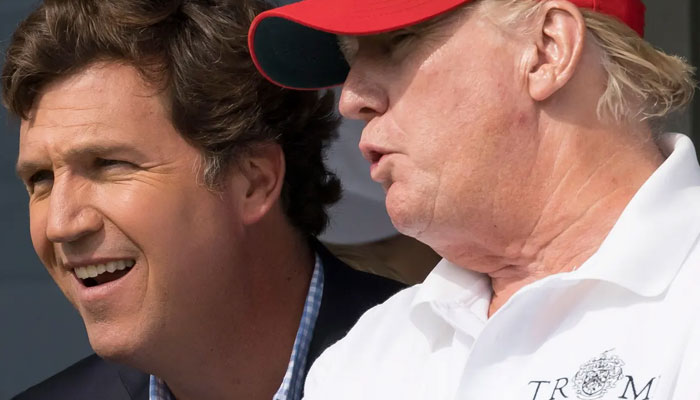 Tucker Carlson, left, and former president Donald Trump at the Trump National Golf Club in Bedminster, New Jersey, in July 2022. — The Telegraph