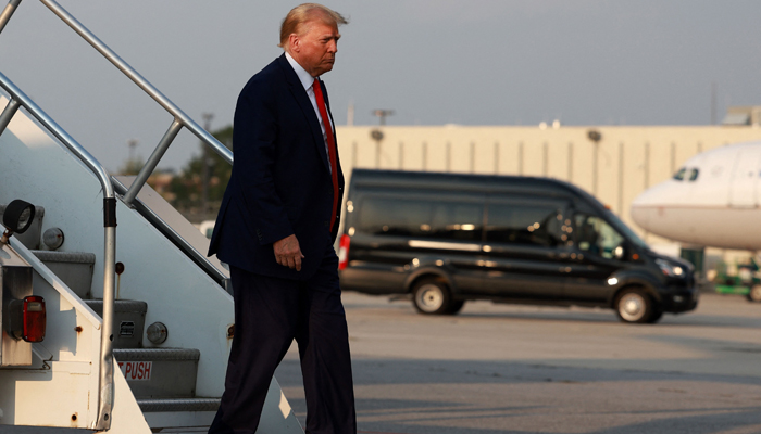 Former U.S. President Donald Trump arrives at Atlanta Hartsfield-Jackson International Airport on August 24, 2023, in Atlanta, Georgia. — AFP