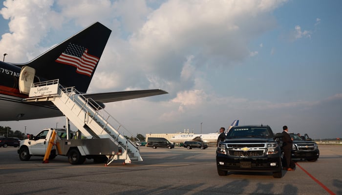 A motorcade waits former US President Donald Trump as he arrives at Atlanta Hartsfield-Jackson International Airport on August 24, 2023, in Atlanta, Georgia. — AFP