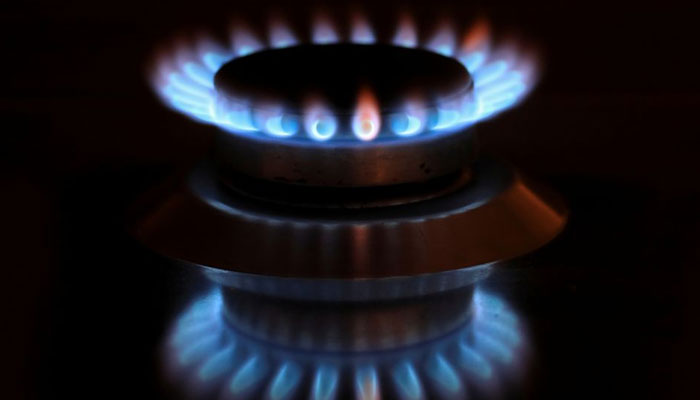 Flames from a gas burner are reflected on a cooker in a private home in Bad Honnef near Bonn, Germany, October 11, 2021. — Reuters