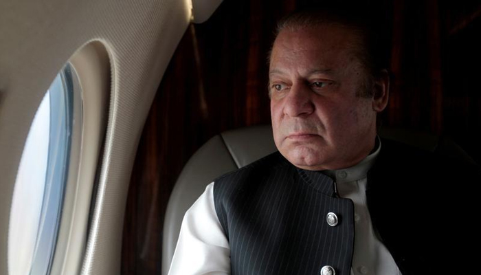 Former Pakistan Prime Minister Nawaz Sharif looks out the window of his plane. — Reuters/File
