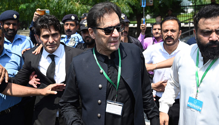 PTI ChairmanImran Khan (C) leaves after appearing in the Supreme Court in Islamabad on July 24, 2023. — AFP