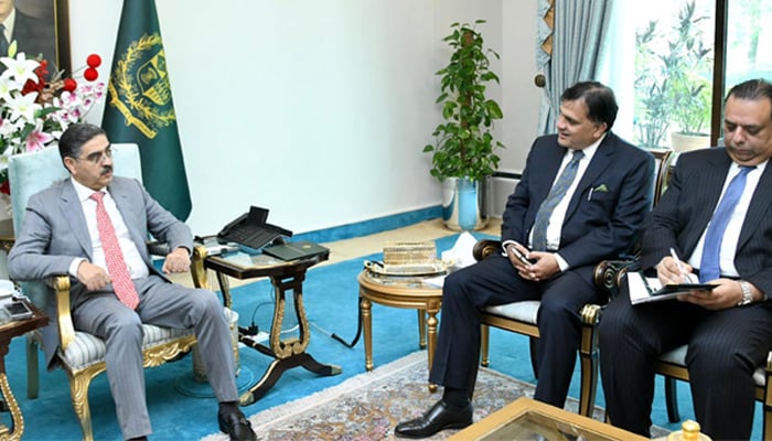 Caretaker PM Anwaar-ul-Haq Kakar (left) and Pakistans HC to the United Kingdom Dr Muhammad Faisal (centre) pictured at a meeting at PM Office on August 25, 2023. — PMO