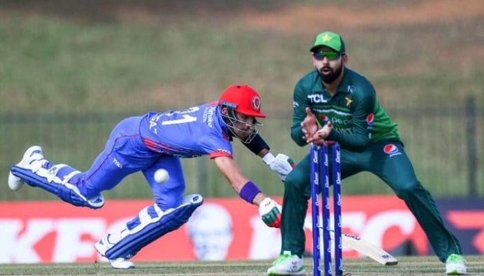 Shadab Khan readies to catch the ball as an Afgan batter dives for run. — PCB