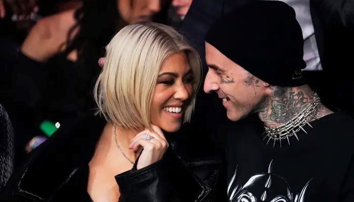 Travis Barker gives sweet kiss to Kourtney Kardashians growing baby bump