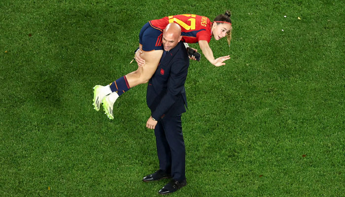 This picture taken on August 20, 2023 shows President of the Royal Spanish Football Federation Luis Rubiales carrying Spain´s Athenea del Castillo Beivide on his shoulder as they celebrate winning the Australia and New Zealand 2023 Women´s World Cup final football match between Spain and England at Stadium Australia in Sydney.—AFP