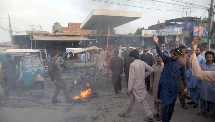 People protest at the Novelty Bridge in Faisalabad against the price hike of electricity and inflation across the country on August 25, 2023. — Online