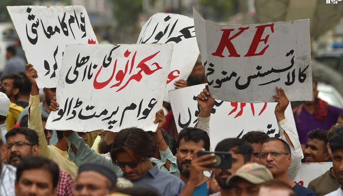 Traders hold placards during a protest against inflation on August 23, 2023. — INP