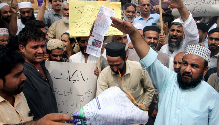 Citizens burn electricity bills as they are holding a protest demonstration against the highly inflated electricity bills, held at Gunj Chowk in Peshawar on Saturday, August 26, 2023. — PPI
