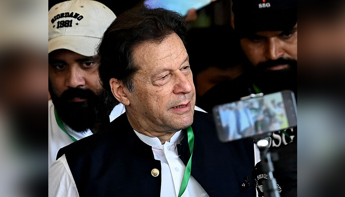 PTI Chairman Imran Khan (centre) leaves after appearing in the Supreme Court in Islamabad on July 26, 2023. — AFP