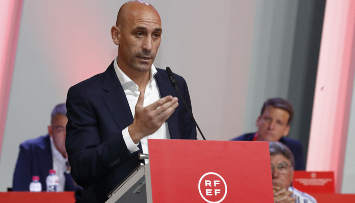This image shows RFEF President Luis Rubiales delivering a speech during an extraordinary general assembly of the federation on August 25, 2023, in Las Rozas de Madrid. — AFP