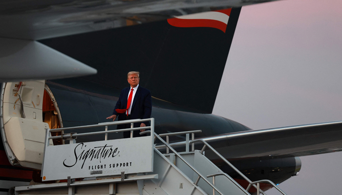 Donald Trump boards his private airplane as he departs Atlanta Hartsfield-Jackson International Airport after being booked at the Fulton County jail on August 24, 2023. — AFP