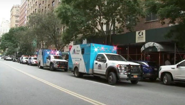 Police vehicles are parked outside the apartment building after four people were stabbed to death in Manhattan New York on Monday, August 28, 2023. — Screengrab/YouTube/Eyewitness News ABC7 NY