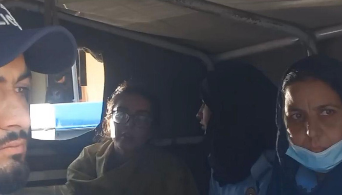 Human rights lawyer Imaan Mazari is seated in a police van outside an Islamabad courts premises on August 29, 2023, in this still taken from a video. — Geo News