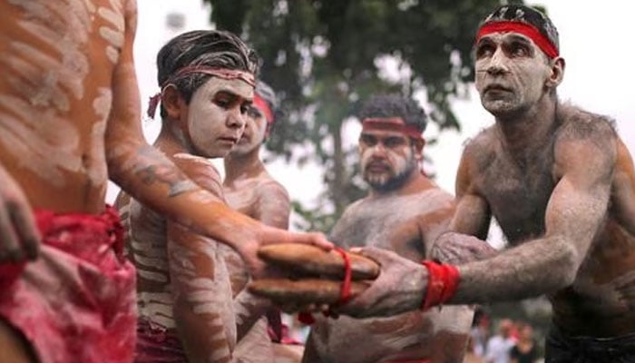 Members of Koomurri Aboriginal Dance Troupe participate in a traditional Australian Aboriginal smoking ceremony as part of celebrations for Australia Day, which marks the arrival of Britains First Fleet in 1788, in central Sydney, Australia, January 26, 2018. —Reuters