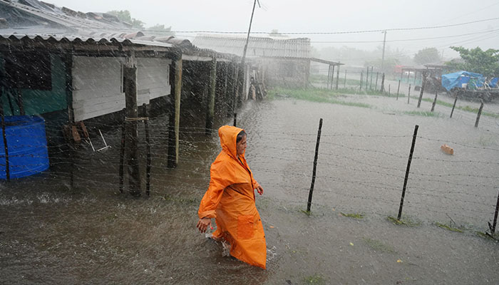A woman walks on a flooded street as Hurricane Idalia makes landfall. — Reuters