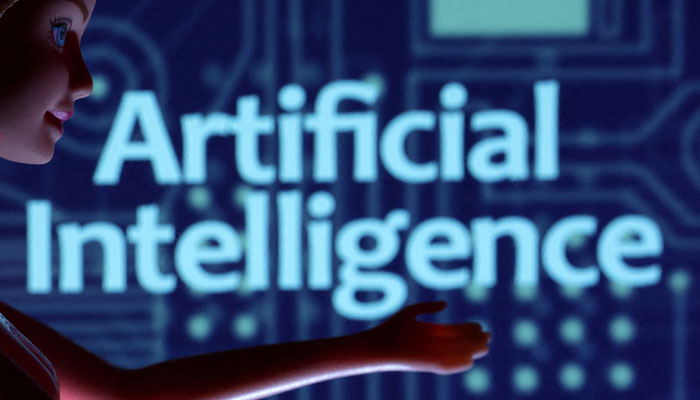 The illustration shows AI bot in front of an Artificial Intelligence poster. — Reuters
