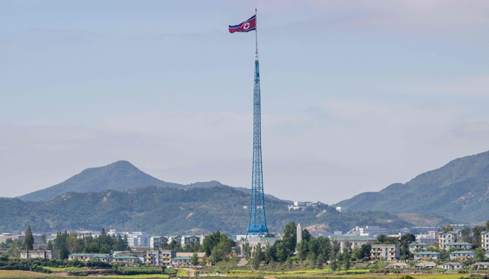 This picture shows a North Korean flag fluttering in the wind at the village of Gijungdong in North Korea on October 4, 2022, near the truce village of Panmunjom inside the Demilitarized Zone (DMZ). — AFP