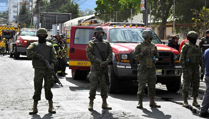 Ecuadorean soldiers stand guard outside the Virgilio Guerrero Detention Centre for Adolescent Offenders after inmates started a fire inside the premises during a riot, in northern Quito, on August 31, 2023. — AFP