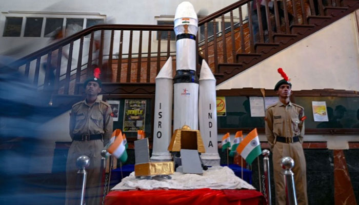 Students of Guru Nanak Khalsa College walk past a model of Indias Chandrayaan-3 spacecraft during an event to celebrate its successful lunar landing, in Mumbai on August 24, 2023. AFP/File