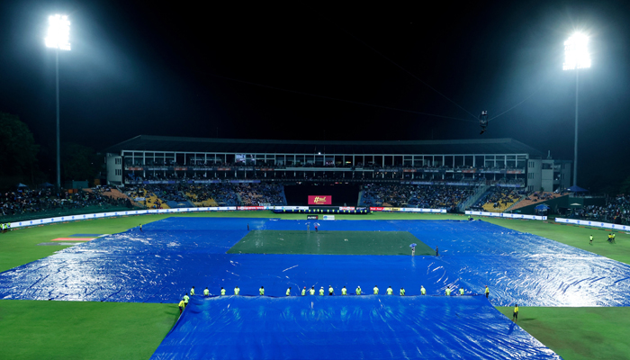 Ground staff covers the field as it pours heavily at the Pallekele Cricket Stadium. — Twitter/@TheRealPCB
