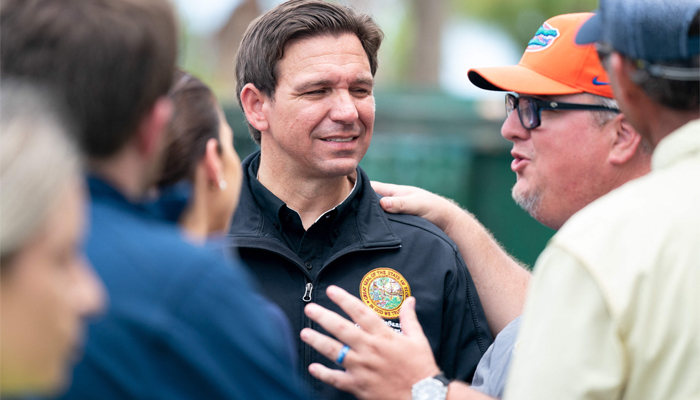Florida Gov. Ron DeSantis, second from left, talks with people before a press conference in the aftermath of Hurricane Idalia on August 31, 2023, in Steinhatchee, Florida. — AFP