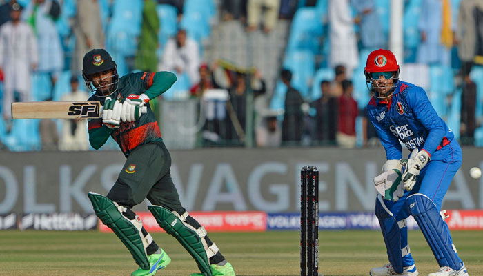 Bangladesh’s Mehidy Hasan Miraz (left) plays a shot during the Asia Cup 2023 one-day international (ODI) cricket match between Bangladesh and Afghanistan at the Gaddafi Stadium in Lahore on September 3, 2023. — AFP