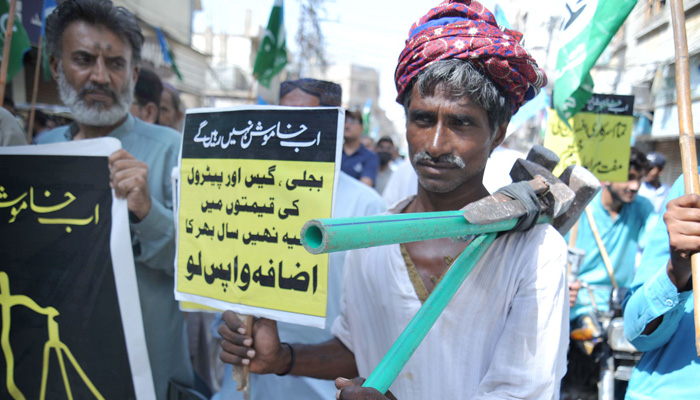 A labourer participates in a protest rally against the surge in electricity and fuel prices in Hyderabad on September 2, 2022. — Online