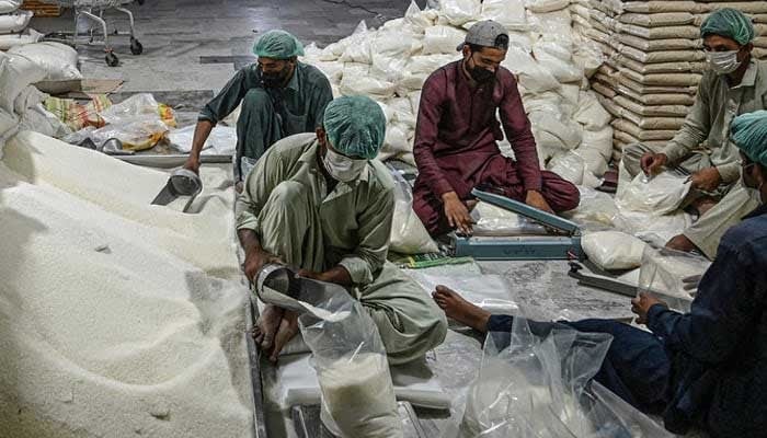 Workers prepare sugar bags to be distributed to people in need, ahead of the Holy month of Ramadan at a warehouse in Islamabad, Pakistan. — AFP/File