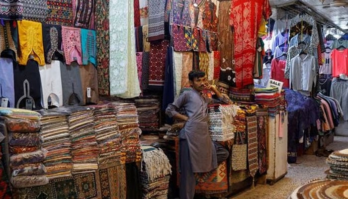 A shopkeeper stands outside his shop while waiting for customers, ahead of Eid al-Fitr celebrations in Karachi, Pakistan April 19, 2023. — Reuters