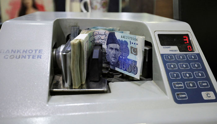 Pakistani rupee notes are seen in a counting machine at a bank in Peshawar, Pakistan August 22, 2023. — Reuters