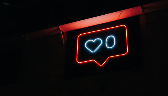 A representational image of a neon light depicting zero Instagram likes. — Unsplash