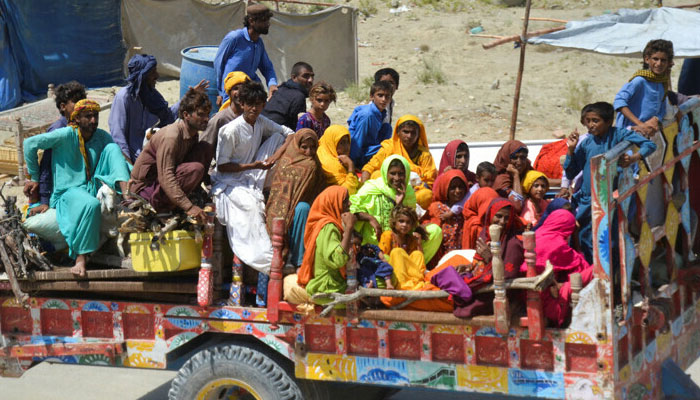 People, displaced because of the floods, travel on a tractor trolly as they head back to their village, following rains and floods during the monsoon season in Sehwan, on September 20, 2022. — Reuters