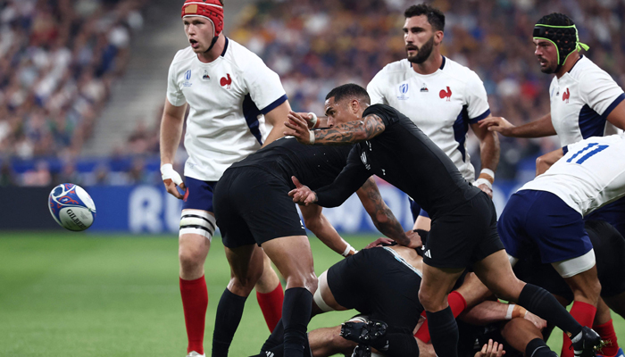 New Zealands scrum-half Aaron Smith (C) passes the ball during the France 2023 Rugby World Cup Pool A match between France and New Zealand at the Stade de France in Paris on September 8, 2023. — AFP