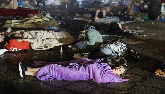 Residents and tourists stay out in a square following an earthquake in Marrakesh on September 9, 2023.—AFP