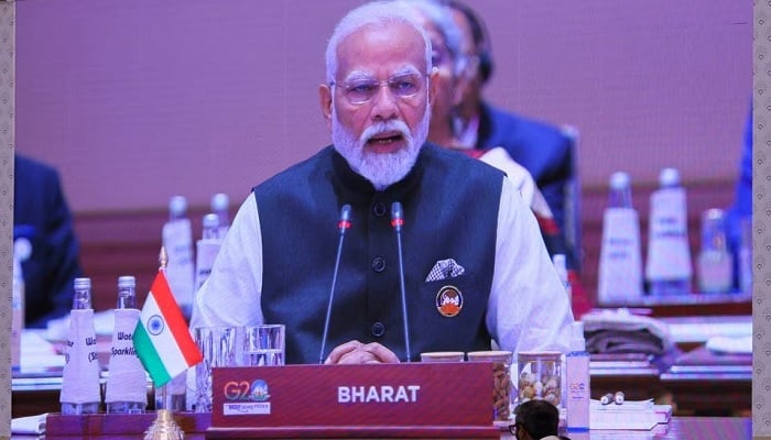 A giant screen displays Indias Prime Minister Narendra Modi at the International Media Centre, as he sits behind the country tag that reads Bharat, while delivering the opening speech during the G20 summit in New Delhi, India, September 9, 2023. —Reuters