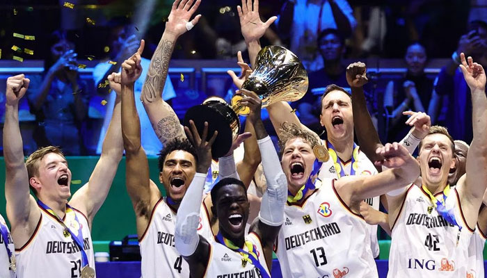 Germanys Dennis Schroder lifts the trophy with teammates after winning the FIBA World Cup 2023 Final, September 10, 2023. — Reuters