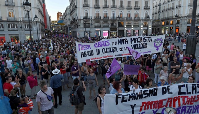 Protestors hold a sign reading Rubiales and macho mafia out during a demonstration called by feminist associations in support of Spains midfielder Jenni Hermoso, in Madrid on August 28, 2023. — AFP